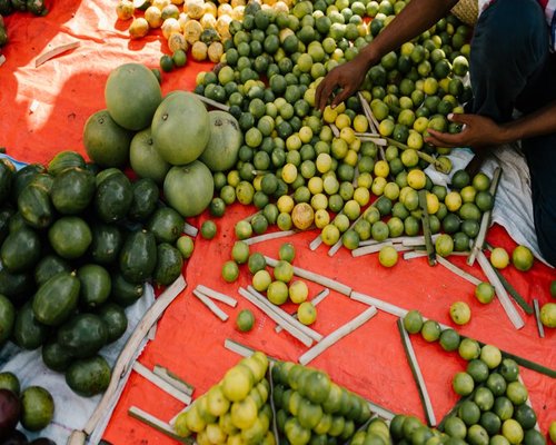 A colorful array of fresh vegetables and fruits at a Kenyan local market
